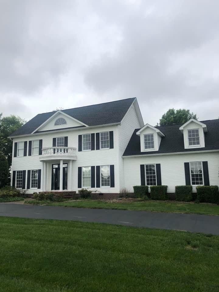 White colonial home with new siding and roof