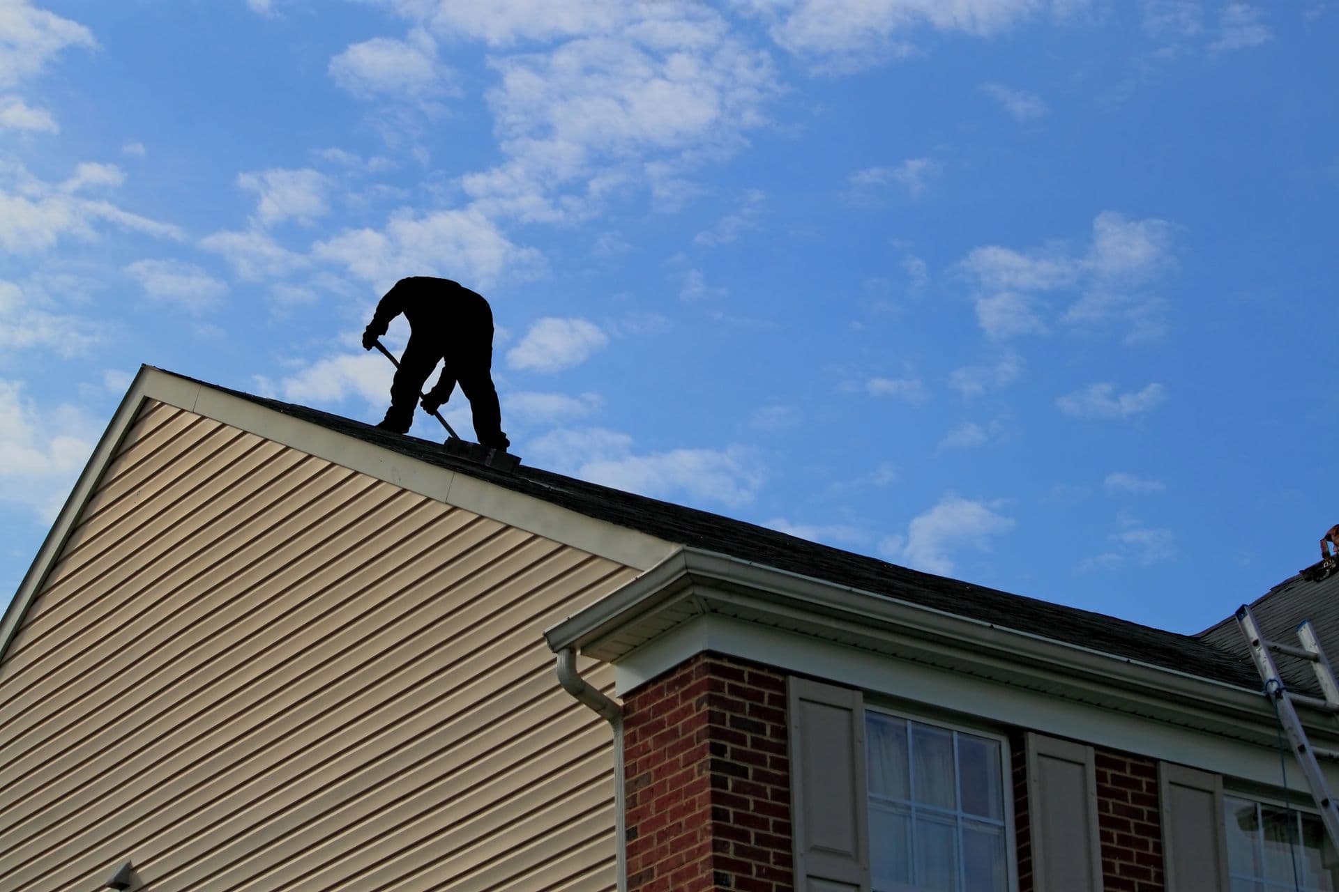 Freedom Contracting roofer working on a residential roof